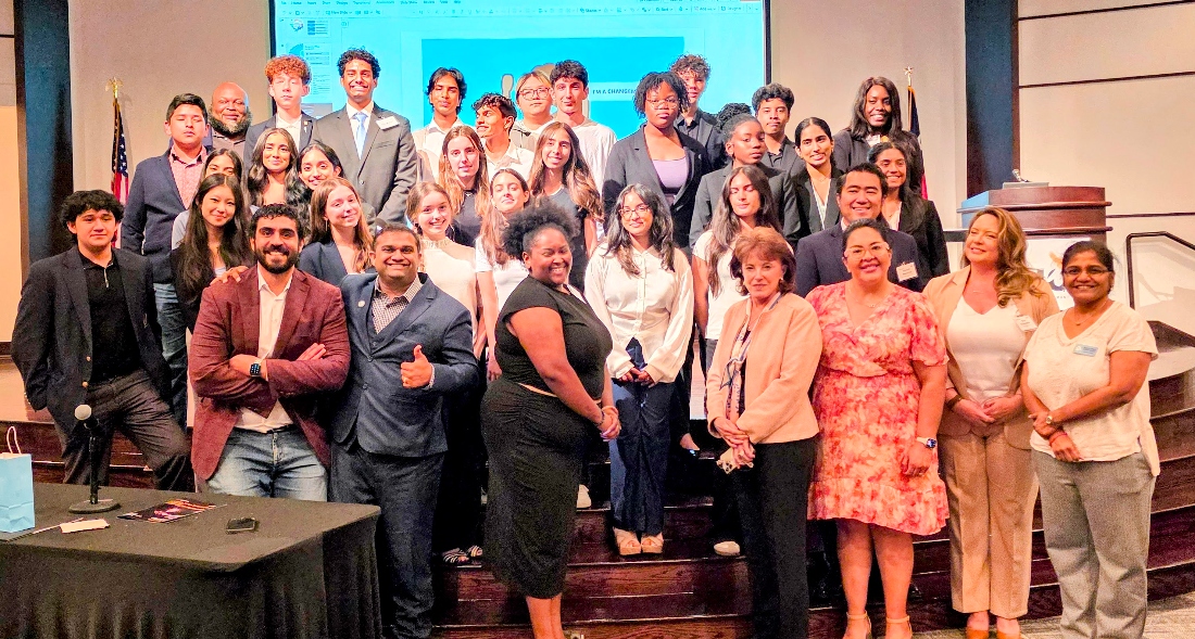 Attendees of the HCC Student Pitchfest Expo and Competition smile as they pose for a group photo at the HCC Southwest College's West Loop Campus.