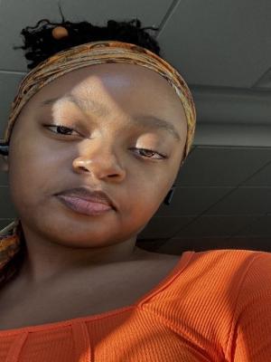 Women taking a selfie in orange colored shirt
