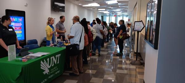 Students talking to college representatives at a Transfer Fair hosted at the Northline campus